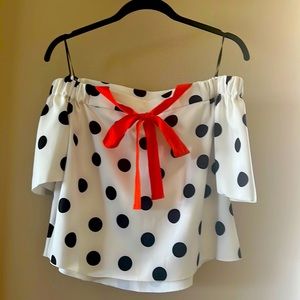 Off the shoulder black and white poke a dot top with orange bow. Super cute!